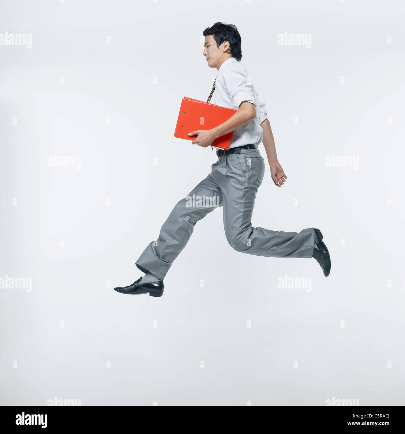 A man jumping with holding files Stock Photo