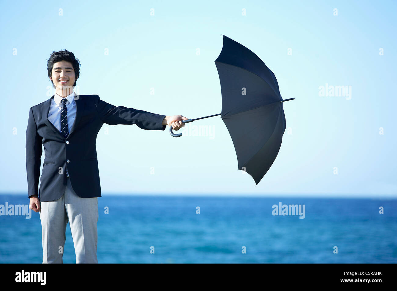A man holding an umbrella Stock Photo - Alamy