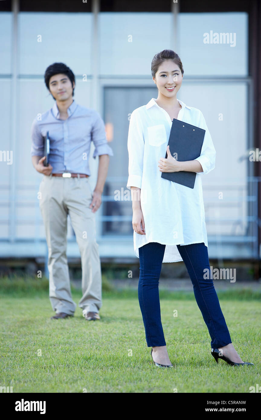 A man and a woman standing on grass Stock Photo - Alamy