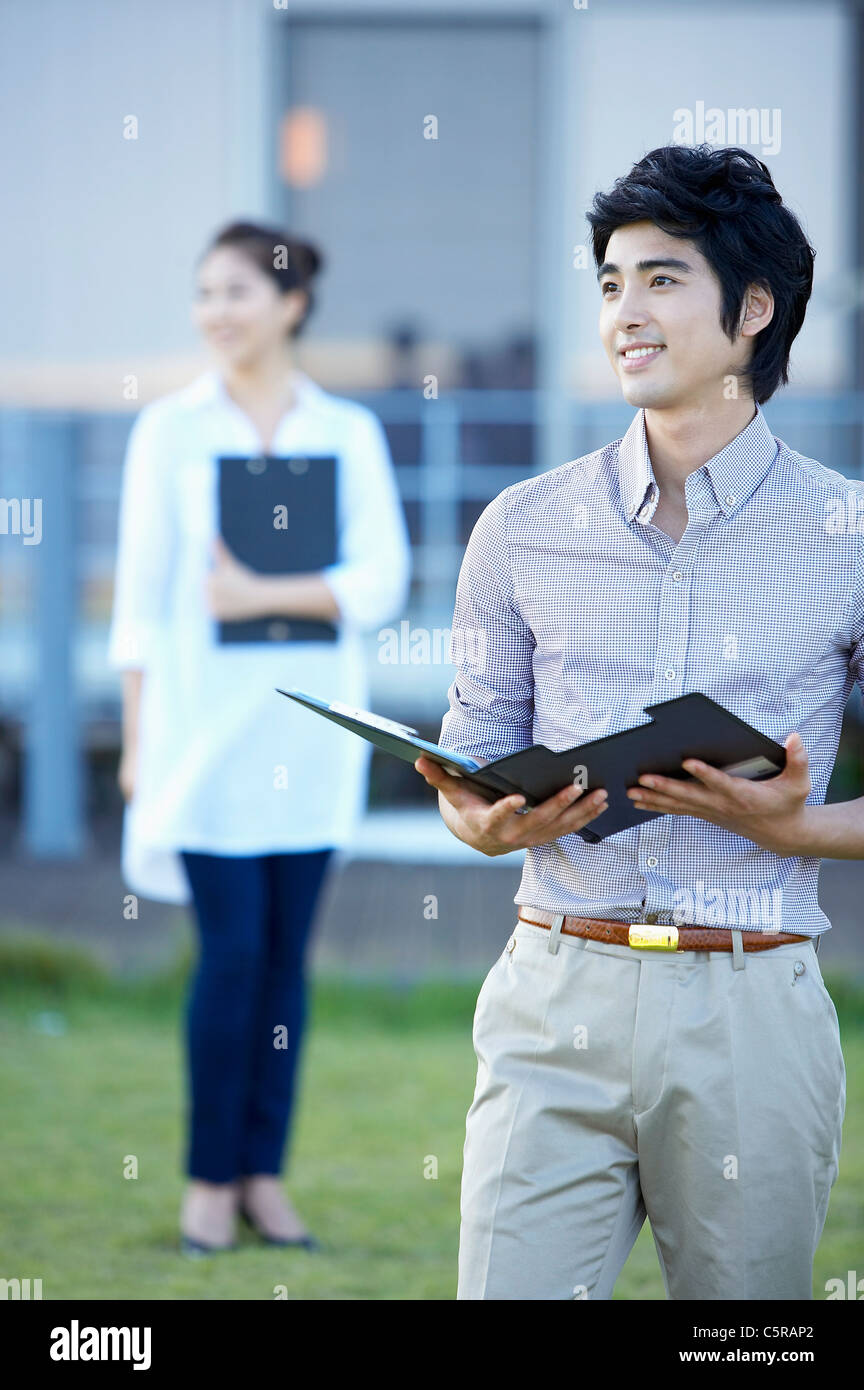 A man and a woman standing on grass Stock Photo - Alamy