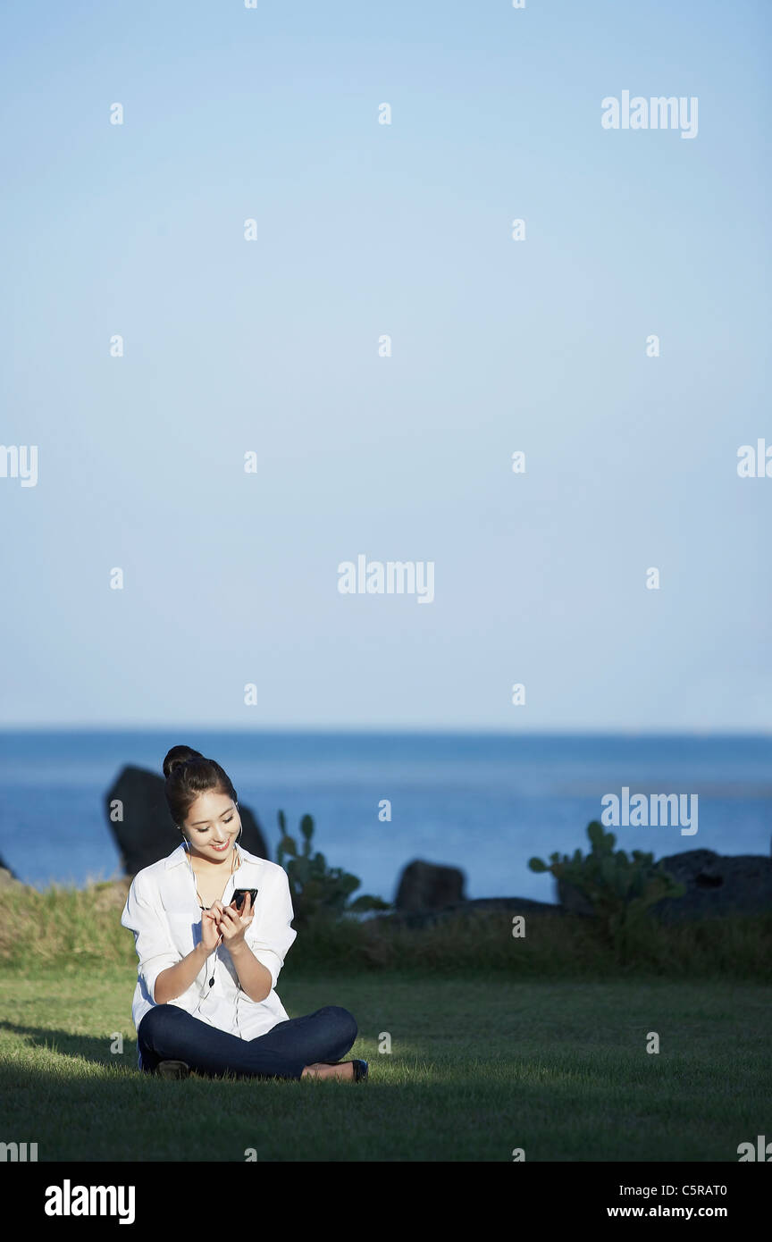 A woman listening to music Stock Photo