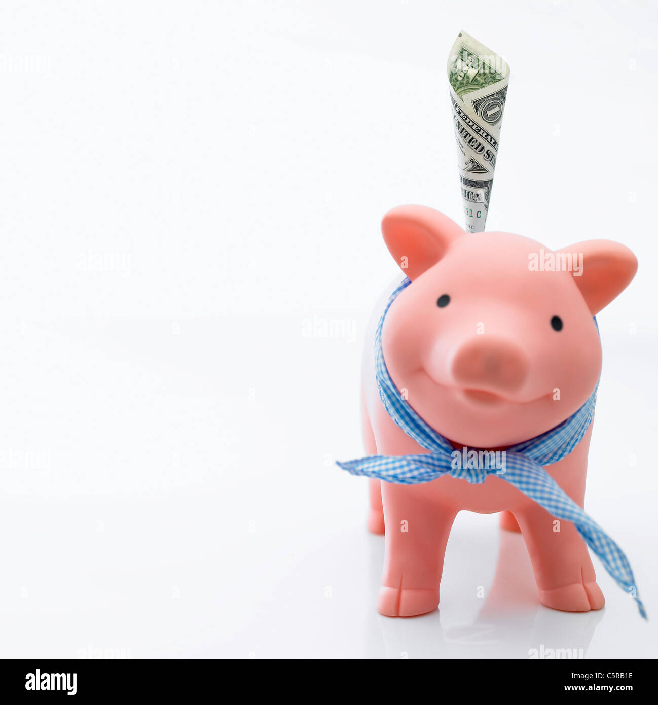 Piggy bank with paper money Stock Photo