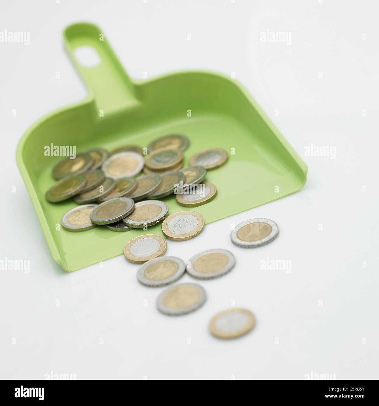 Coins in dustpan Stock Photo Alamy