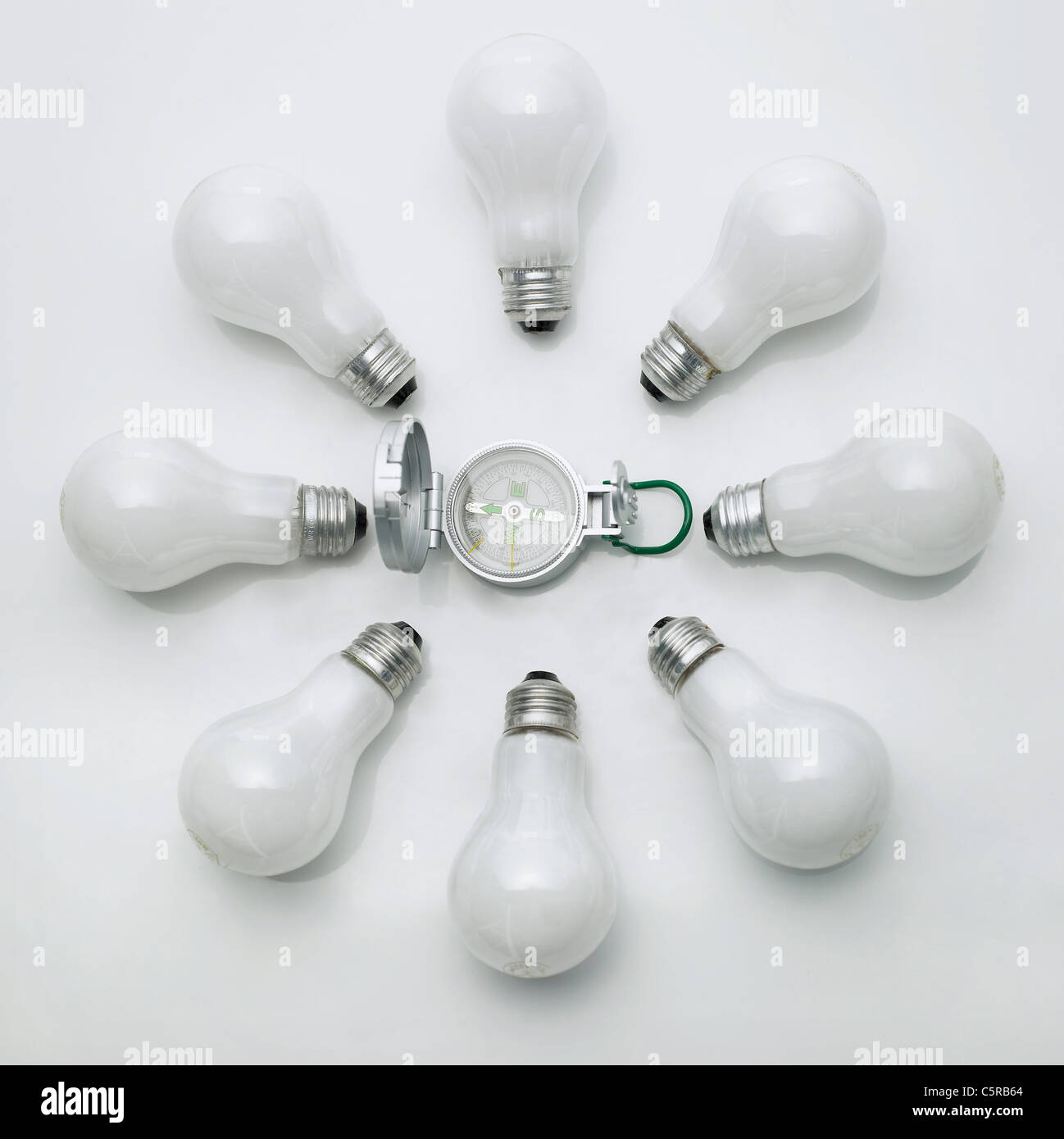 A compass surrounded by light bulbs Stock Photo Alamy