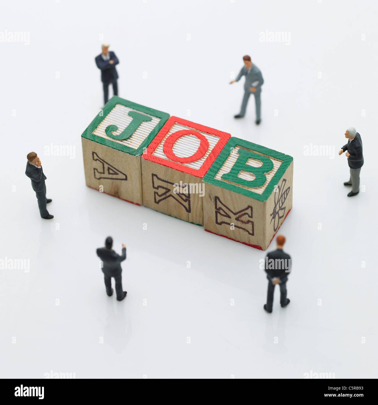 Figurines around the toy block Stock Photo Alamy