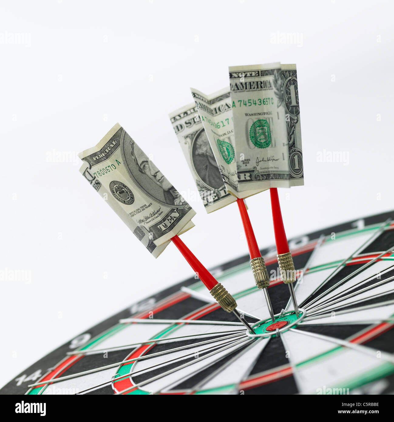 Paper money hit on the dart board Stock Photo