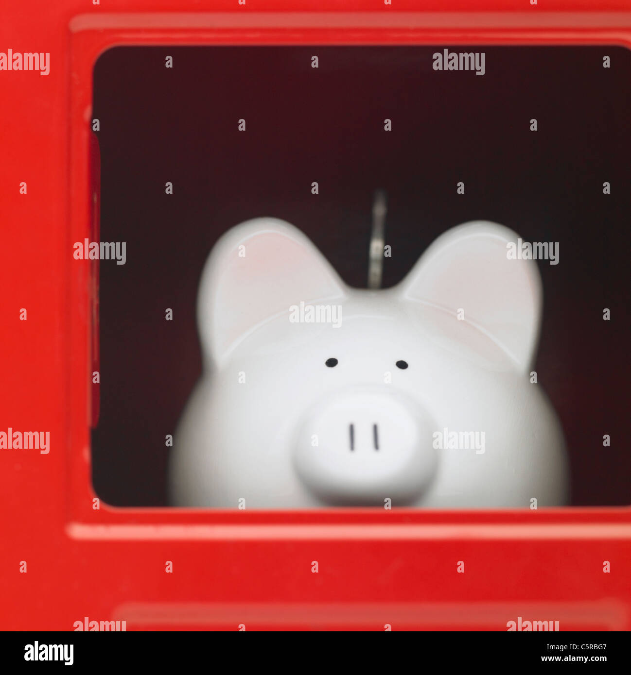 A piggy bank inside a safe Stock Photo