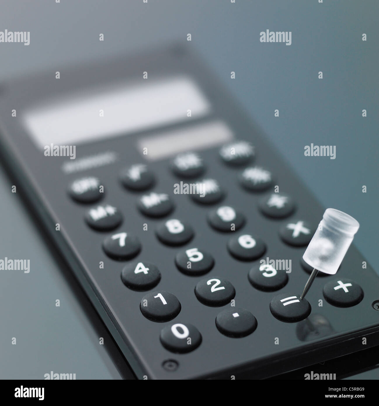A calculator and a tack Stock Photo