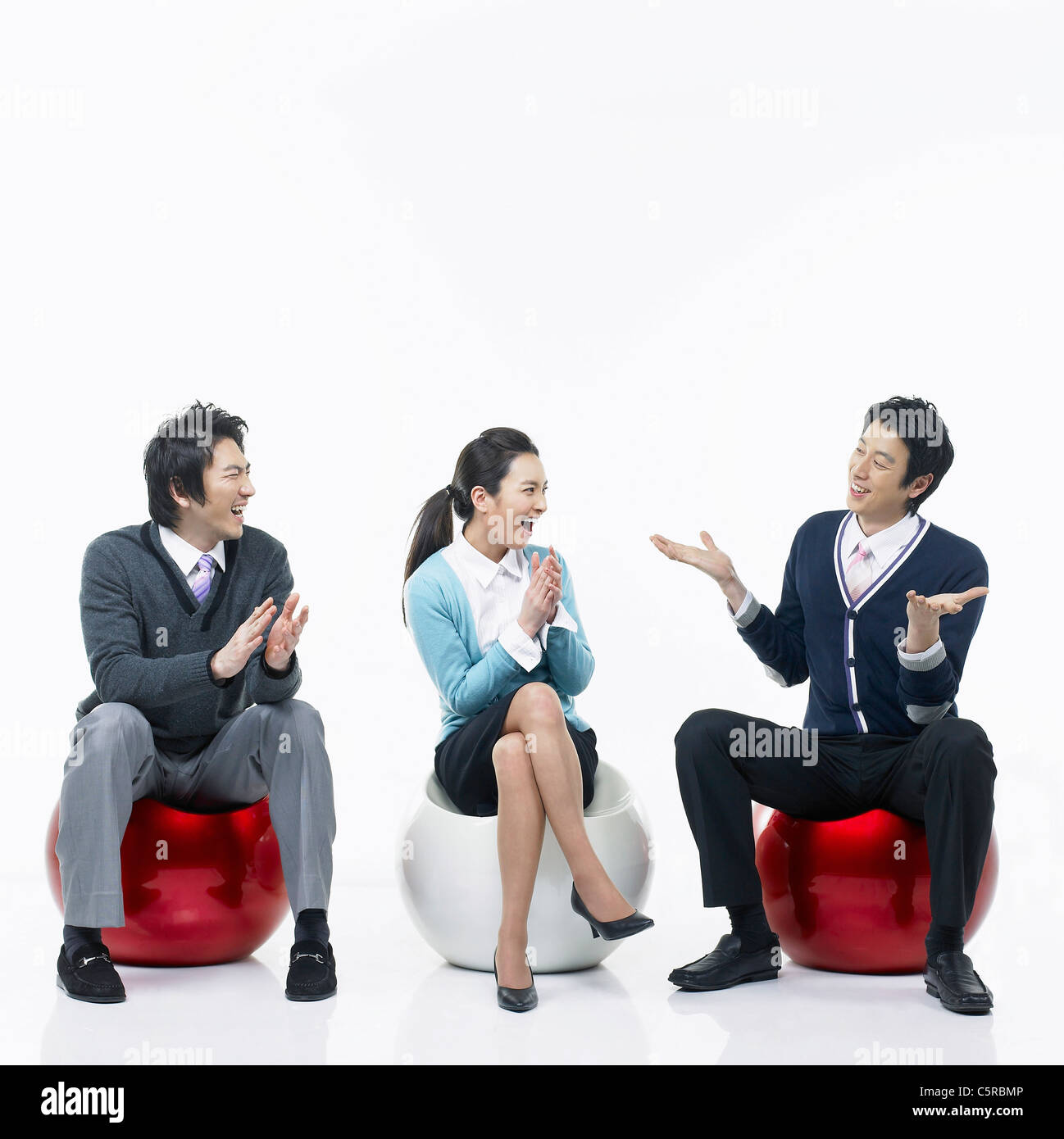 Three people having conversation Stock Photo - Alamy