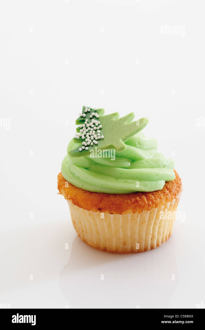 Close up of woodruff buttercream cupcake with christmas sticker against white background Stock Photo