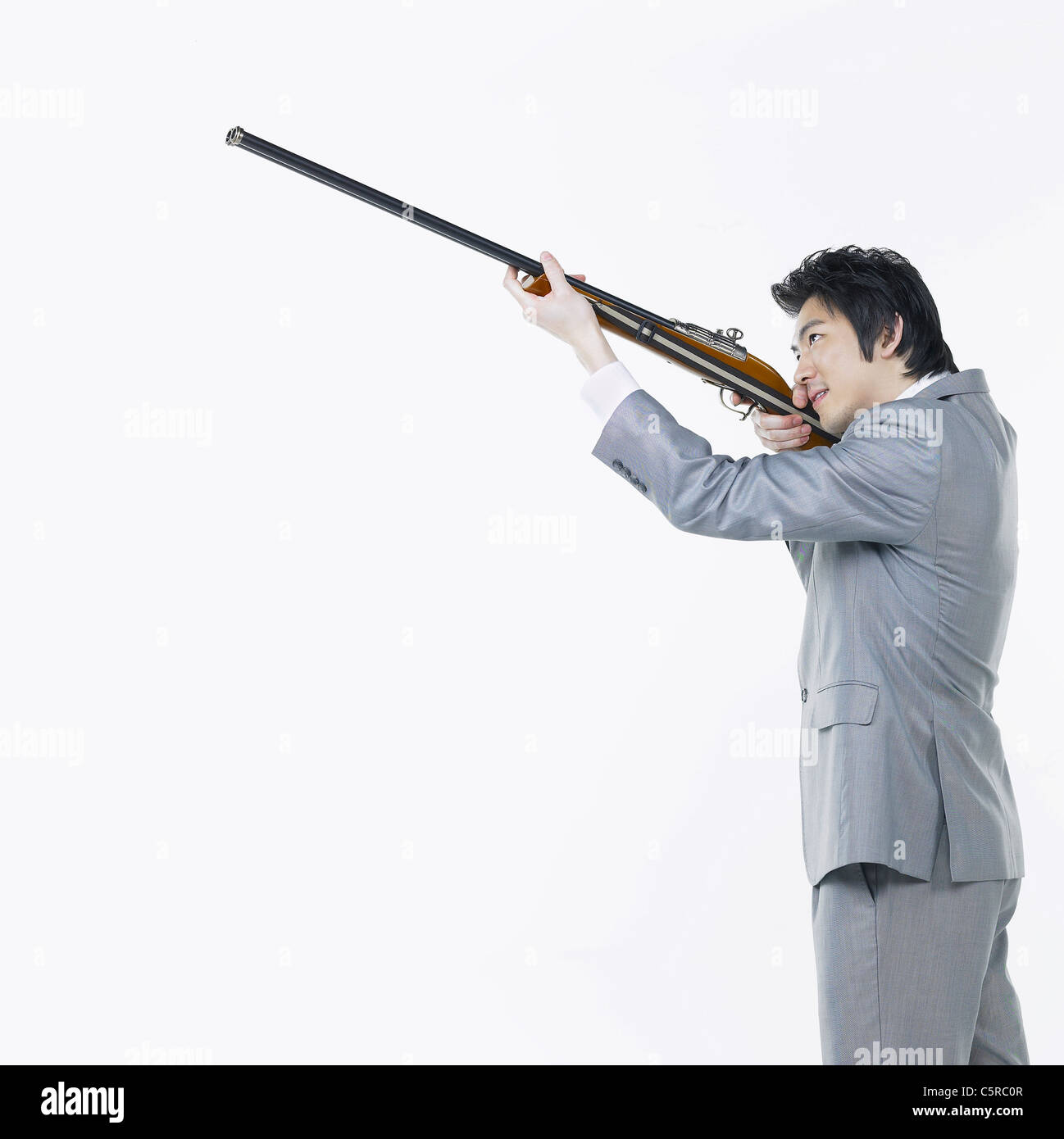A man aiming with a shotgun Stock Photo