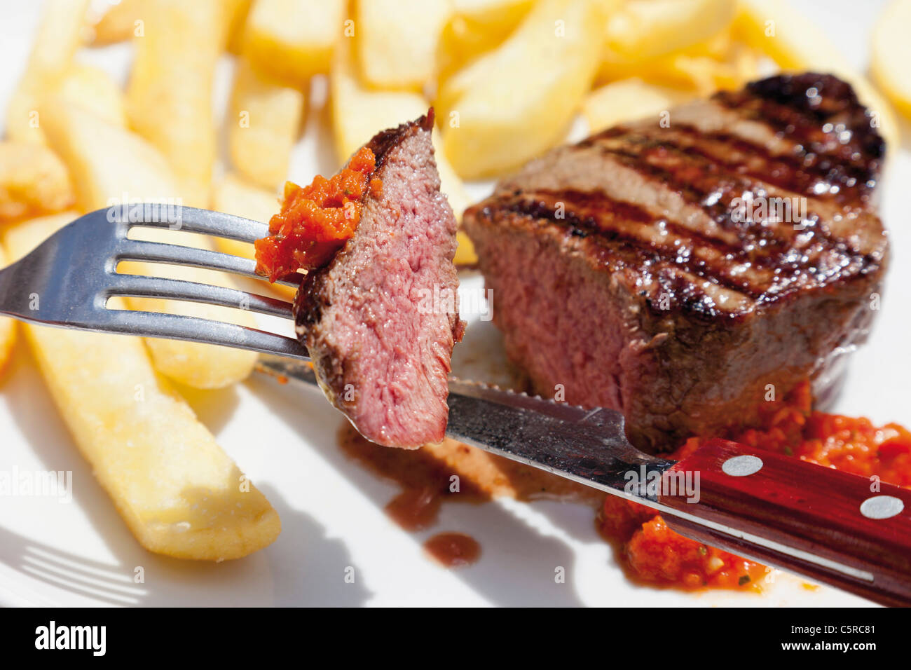 Close up of barbecued beef steak with french fries Stock Photo