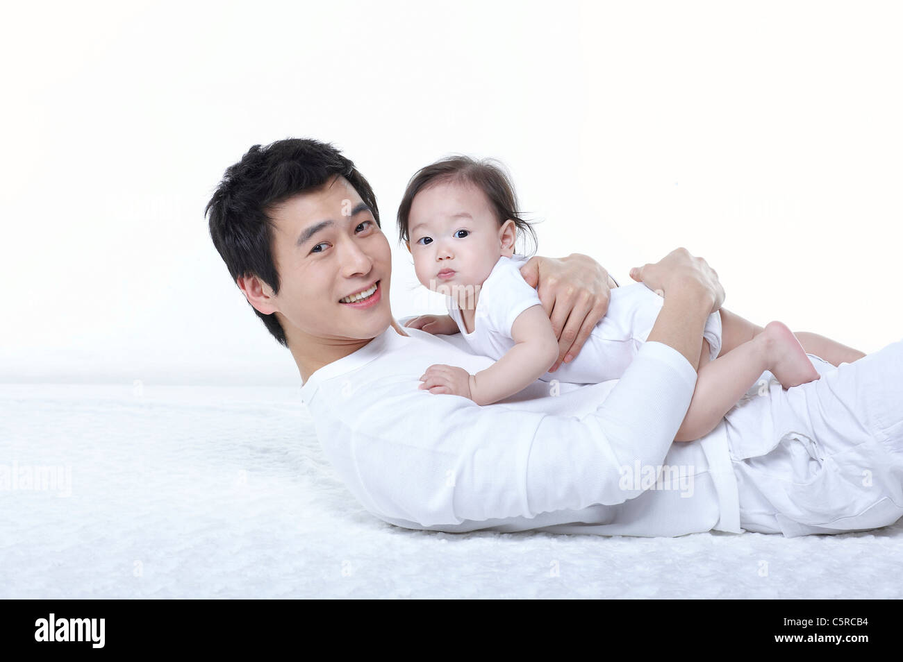 Father lying with his baby Stock Photo - Alamy