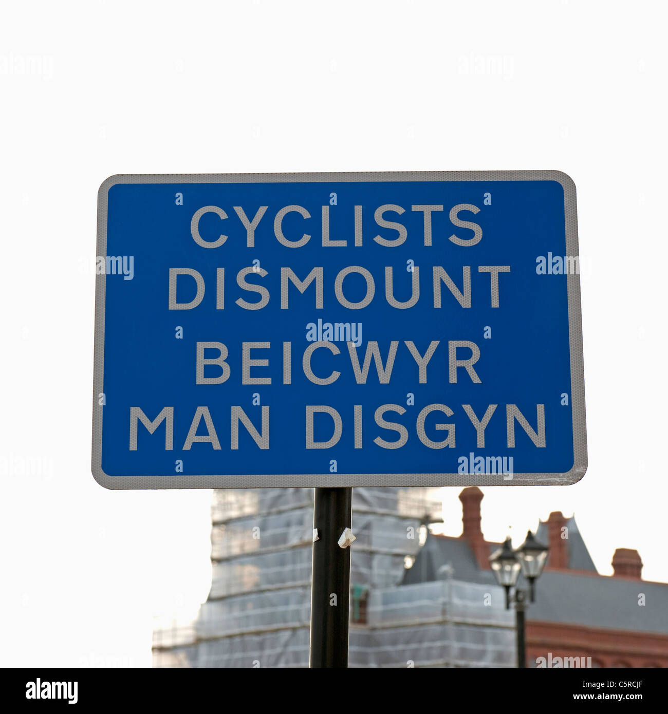 Bilingual cyclists dismount sign in both Welsh and English languages in Cardiff. Stock Photo