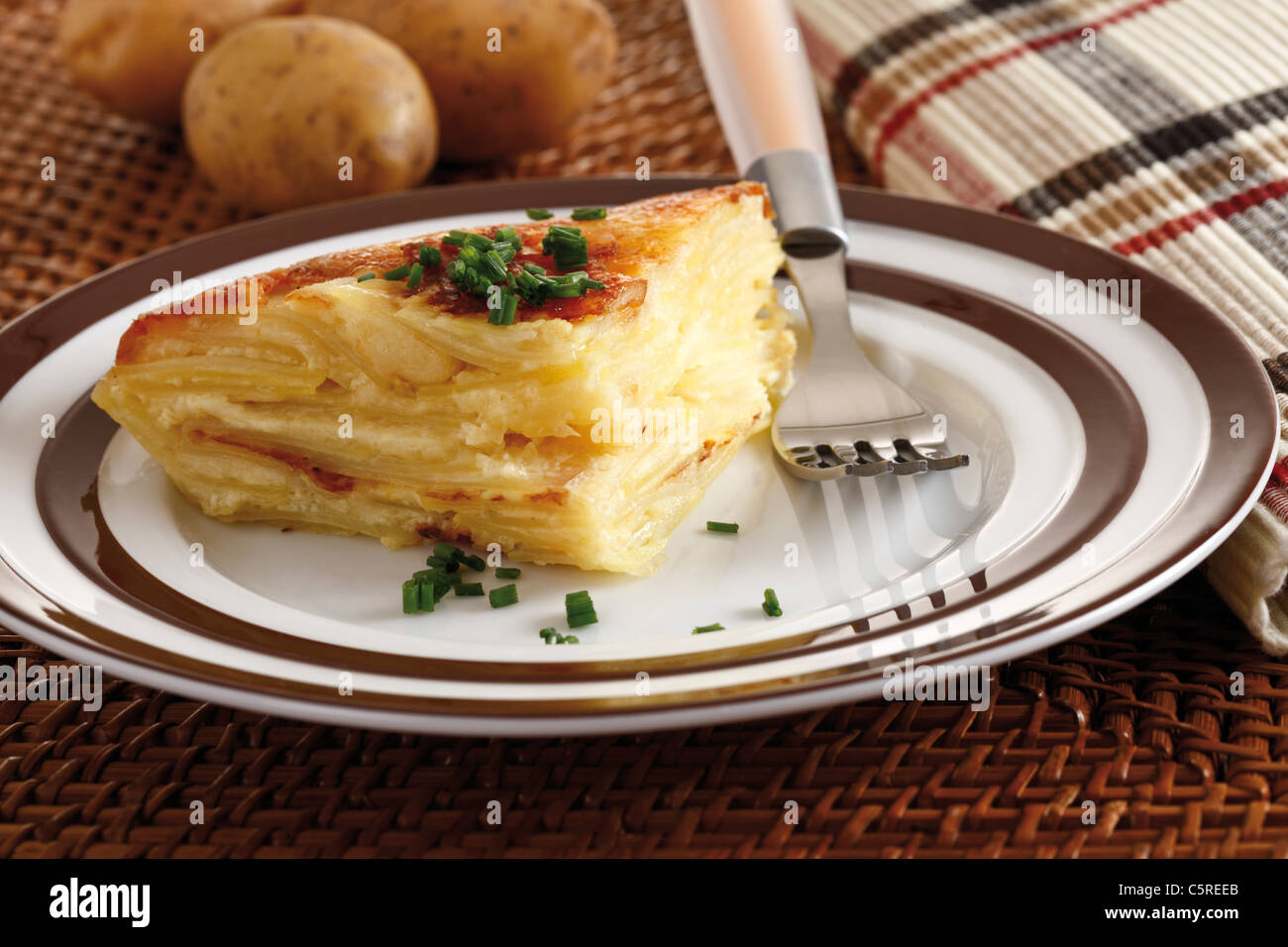 Piece of potato bake on plate, elevated view Stock Photo
