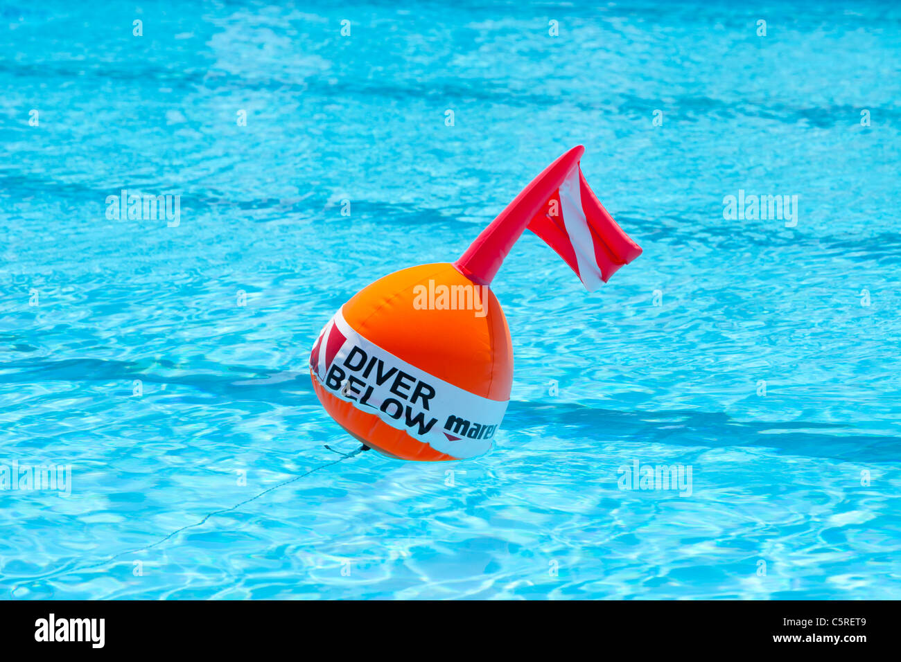 A diver below warning buoy on a swimming pool at a holiday village in