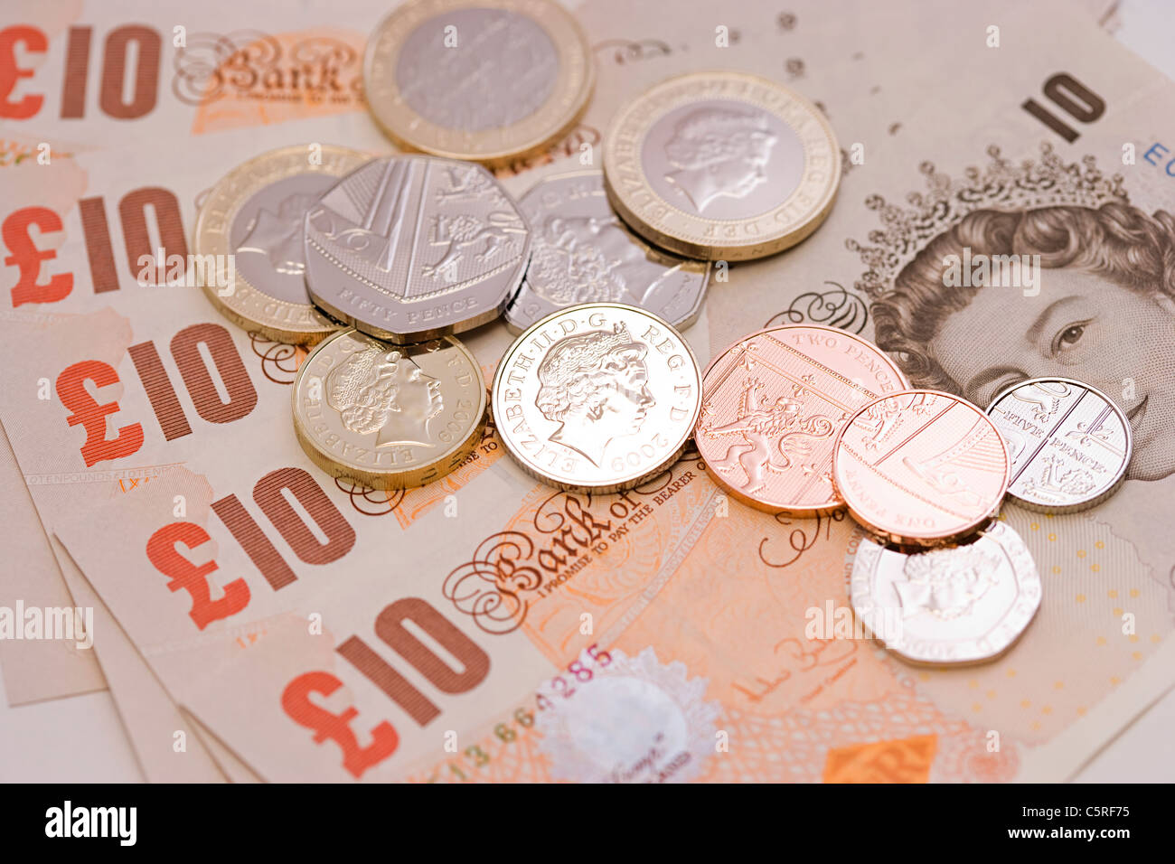 new and unused fan of UK Sterling ten pound bank notes with mint coins