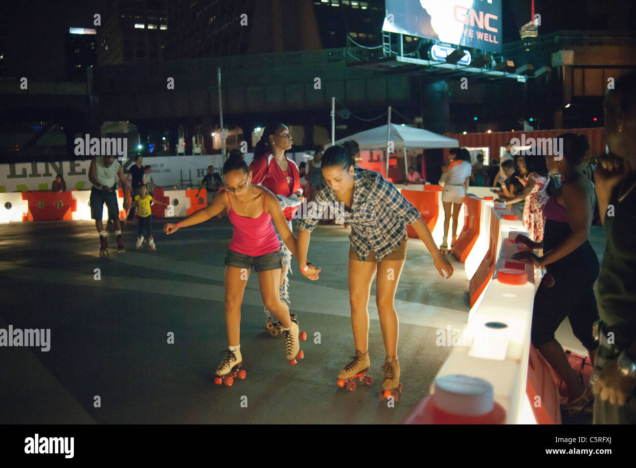 Roller skaters of various skill levels maneuver the new rink below the