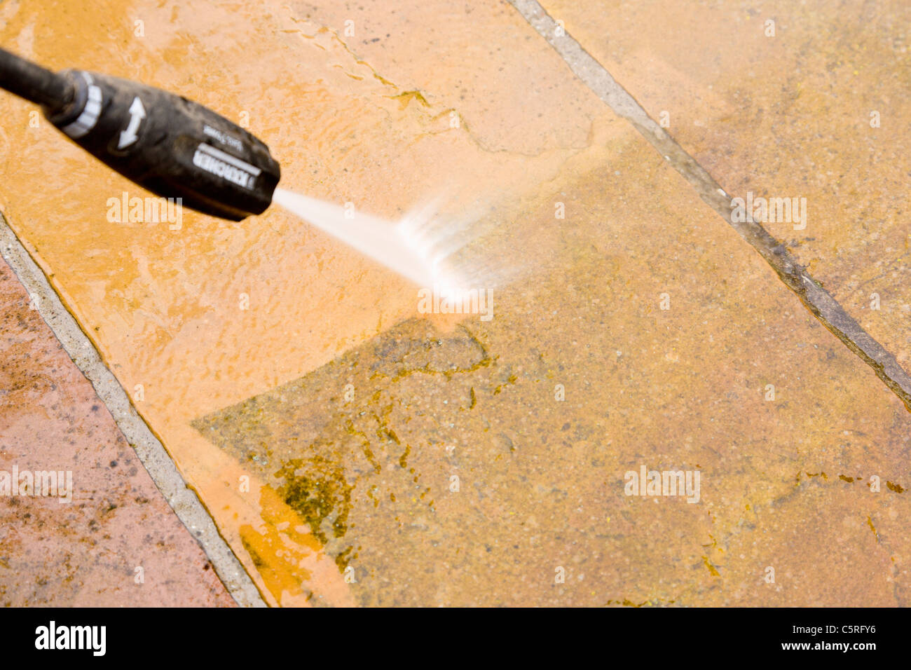 Jet washing a patio Stock Photo Alamy
