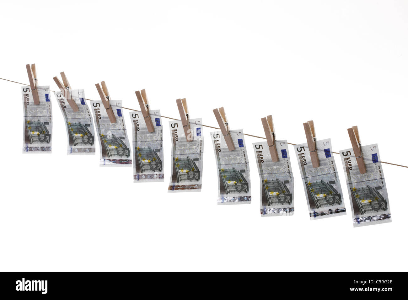 5 Euro bank notes hanging on clothesline Stock Photo