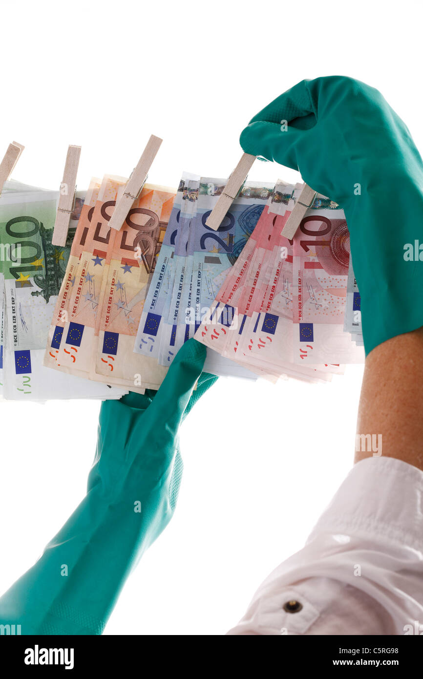 Person hanging different Euro notes  on clothesline, close-up Stock Photo