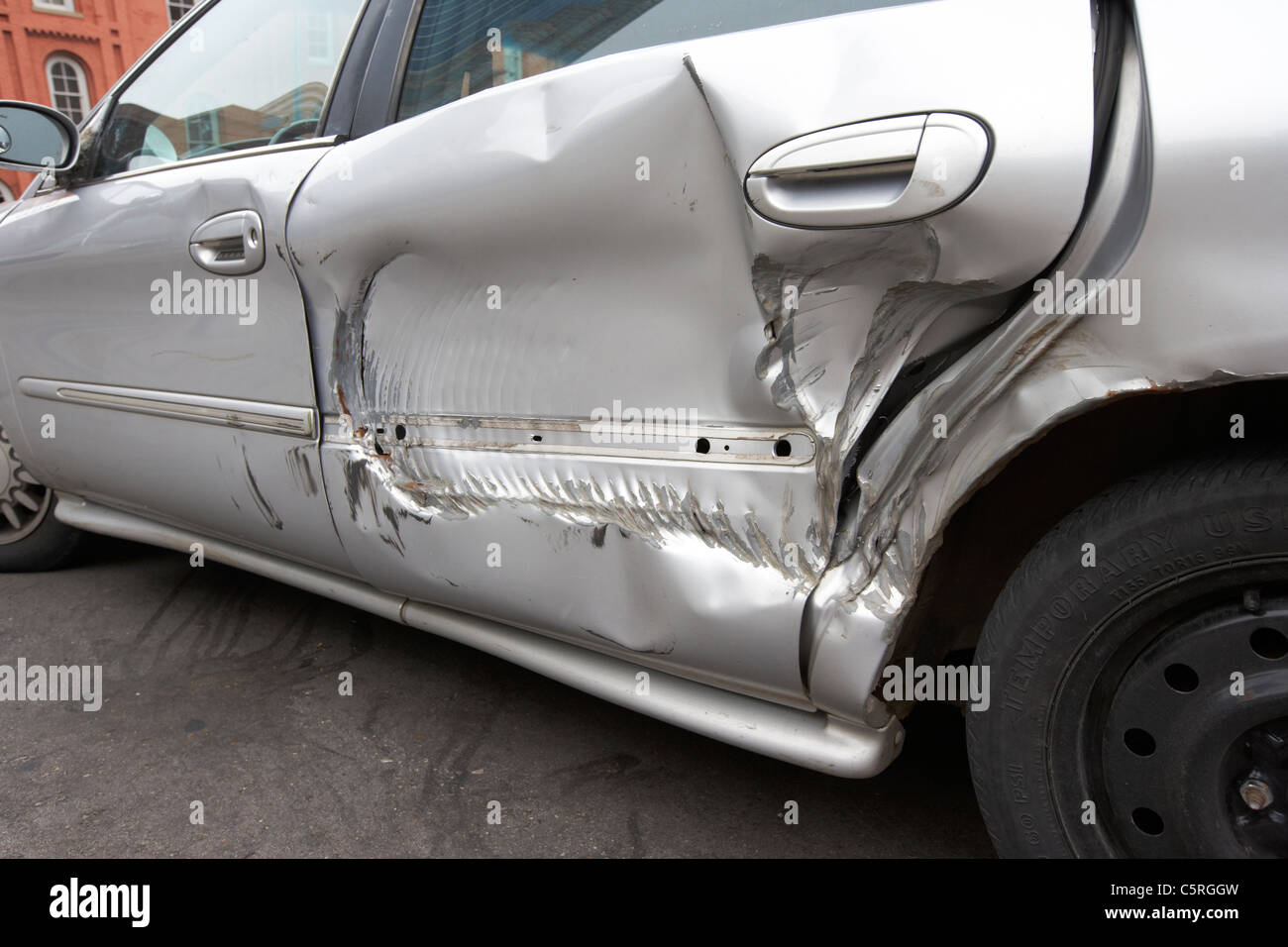 damaged rear door of a car damaged by truck wheel Nashville Tennessee USA Stock Photo