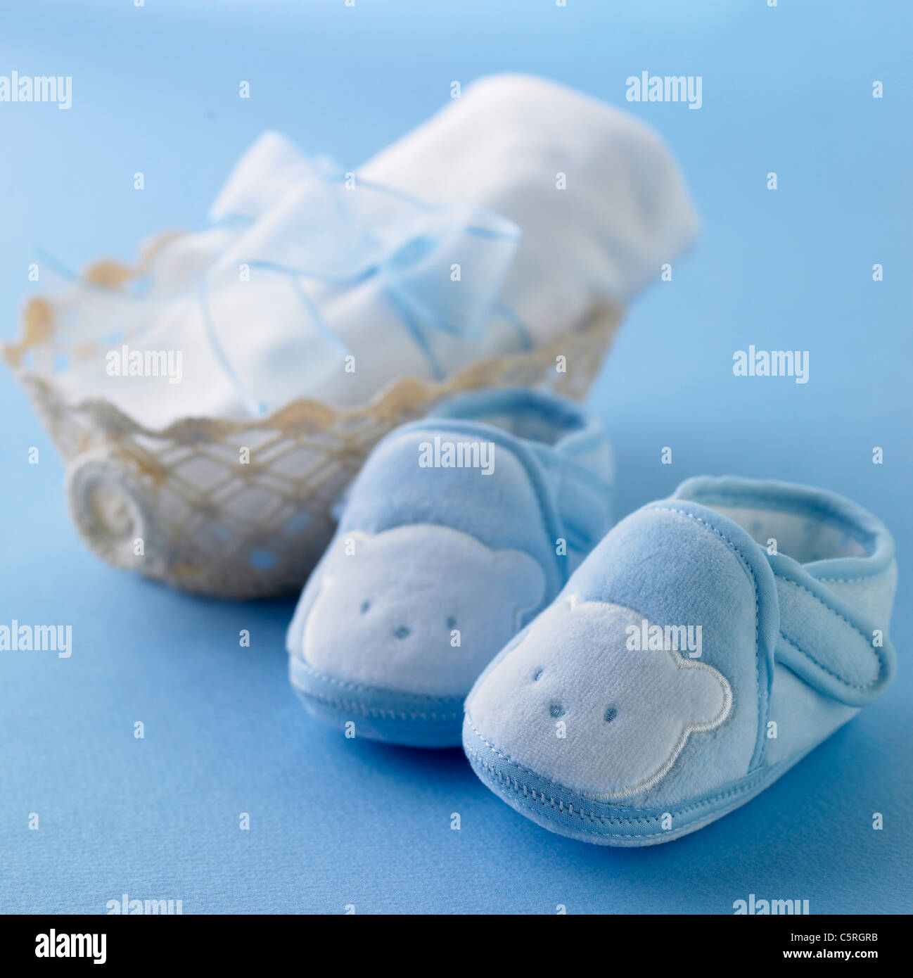 Baby's shoes and a basket Stock Photo