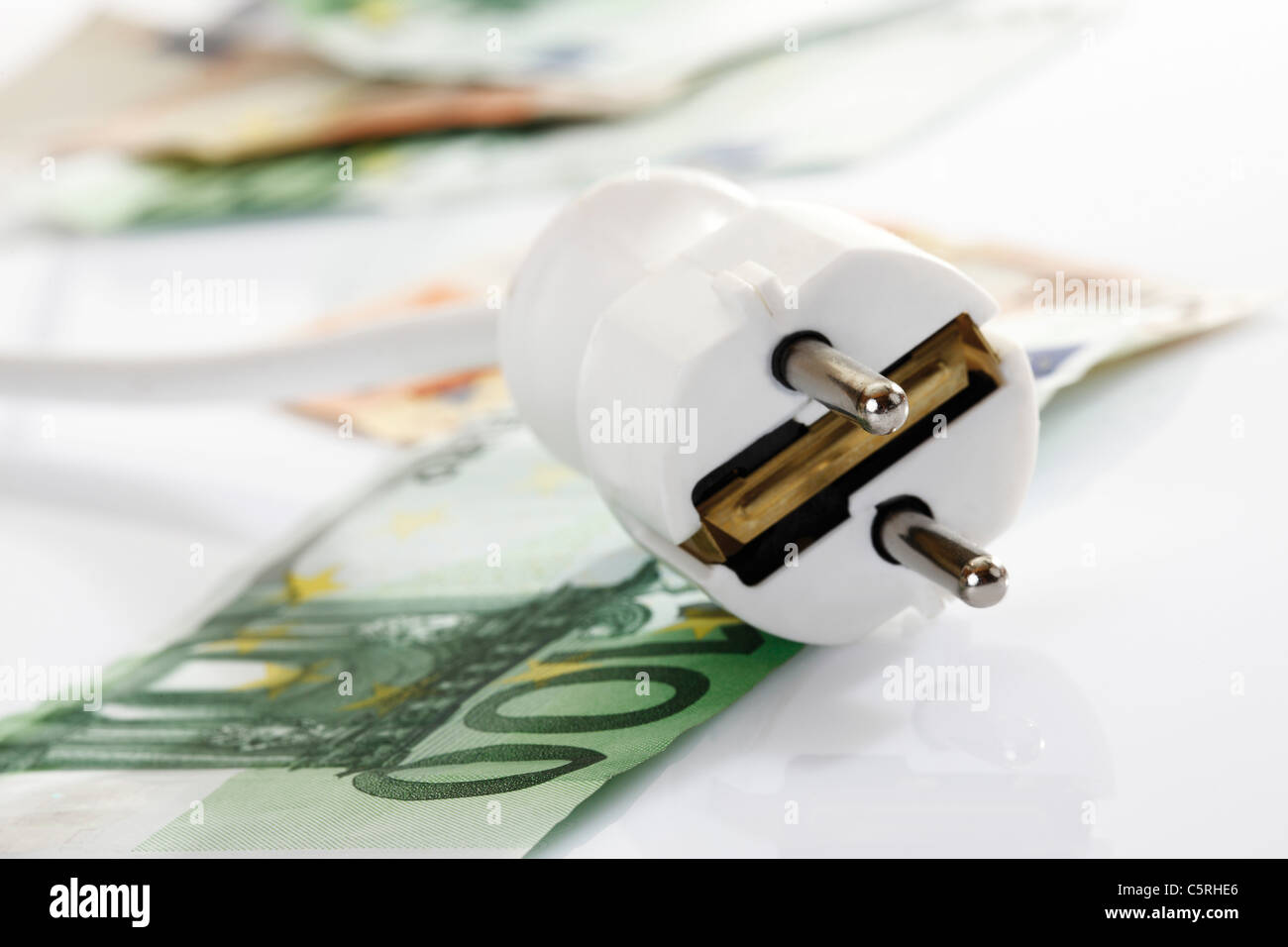 White  plug and banknotes, close-up Stock Photo