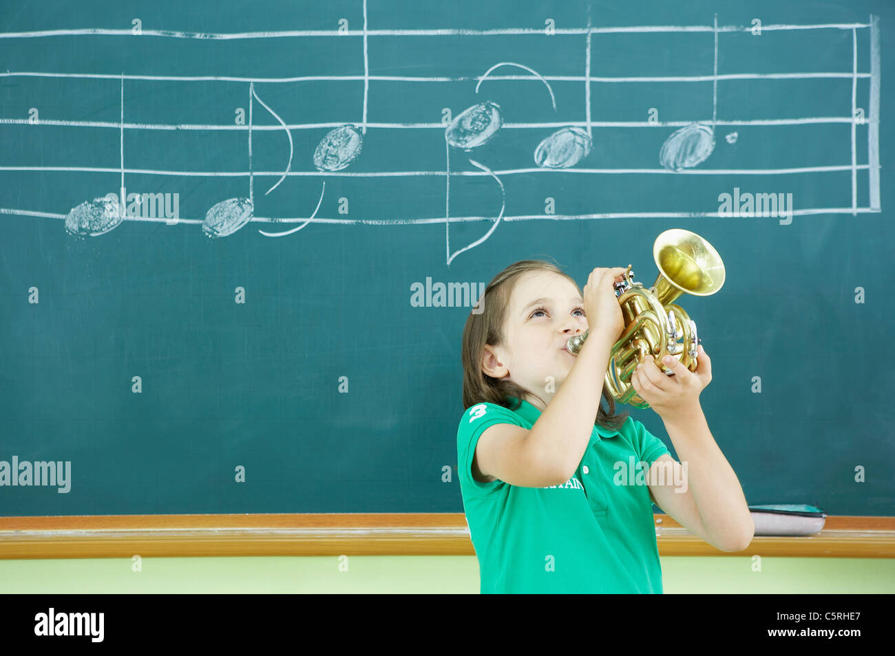 A Caucasian girl playing a trumpet Stock Photo