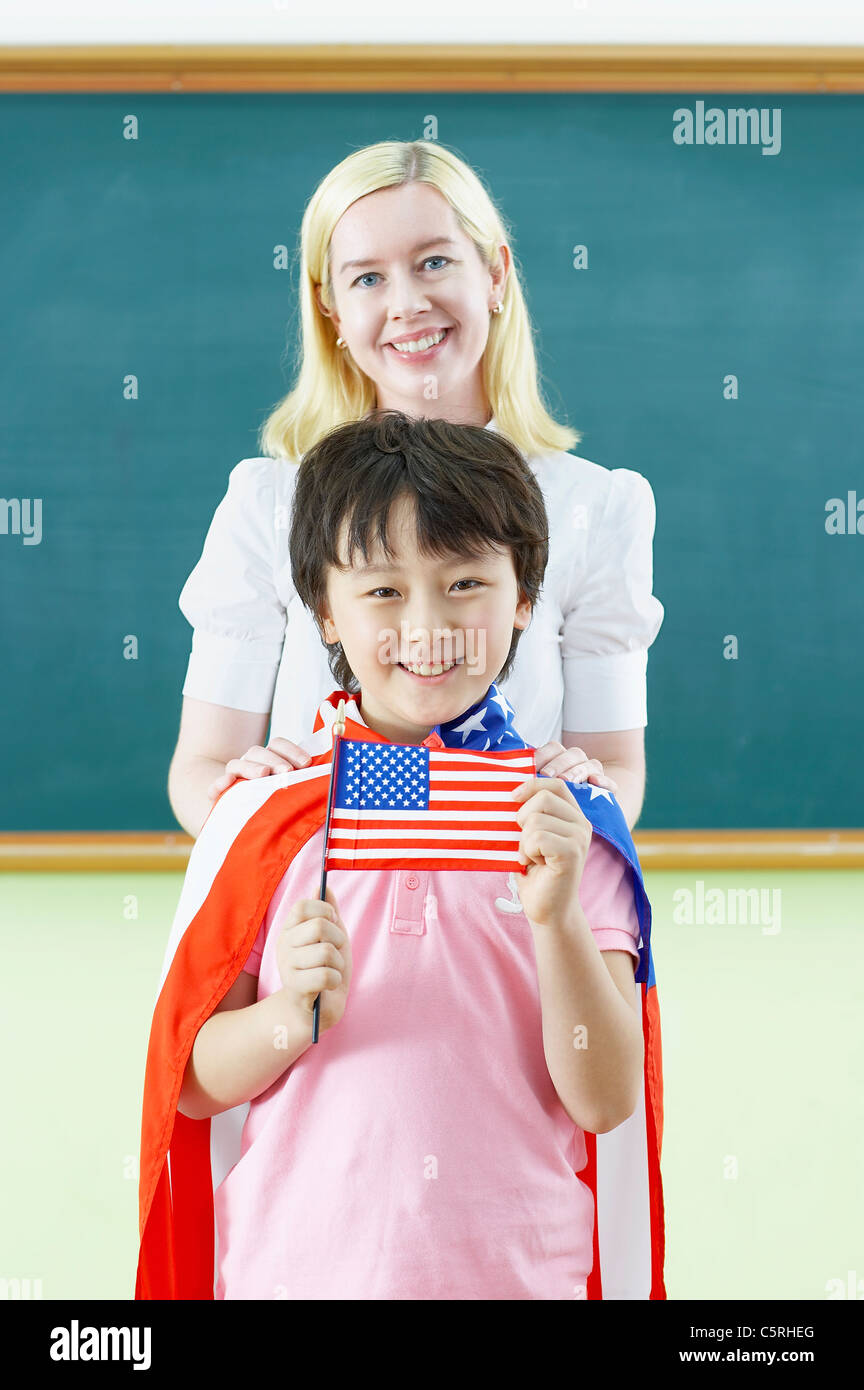 A boy wearing American flag and a teacher smiling together Stock Photo