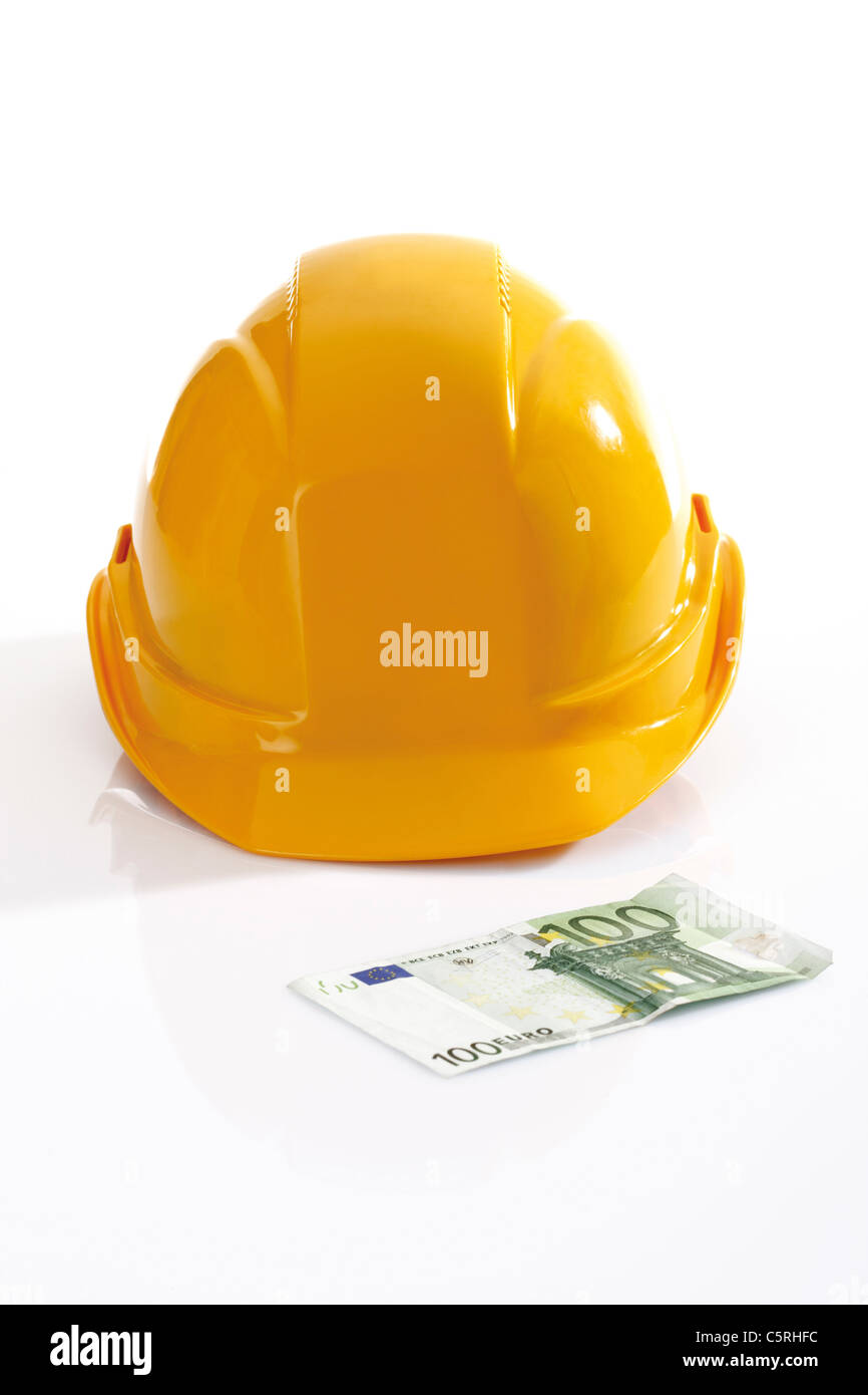 Hardhat and 100 Euro bank note Stock Photo