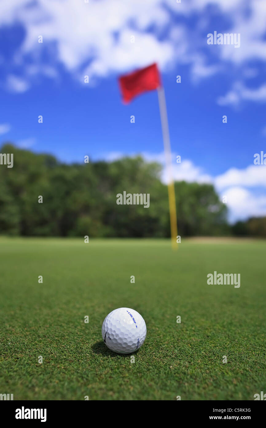 Golf ball on green, close up view. Stock Photo