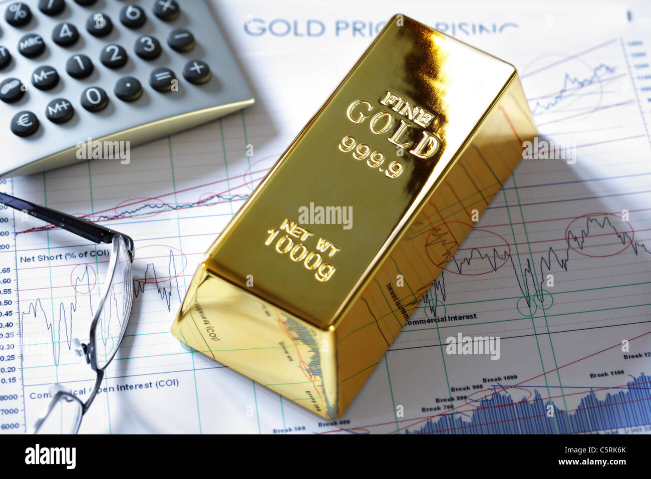 Gold bullion barr on a stocks and shares chart Stock Photo