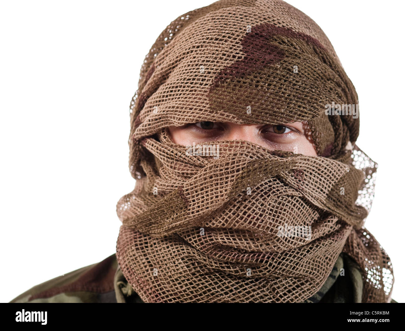 A hidden face of a guerrilla warrior with serious stare on eyes. Stock Photo