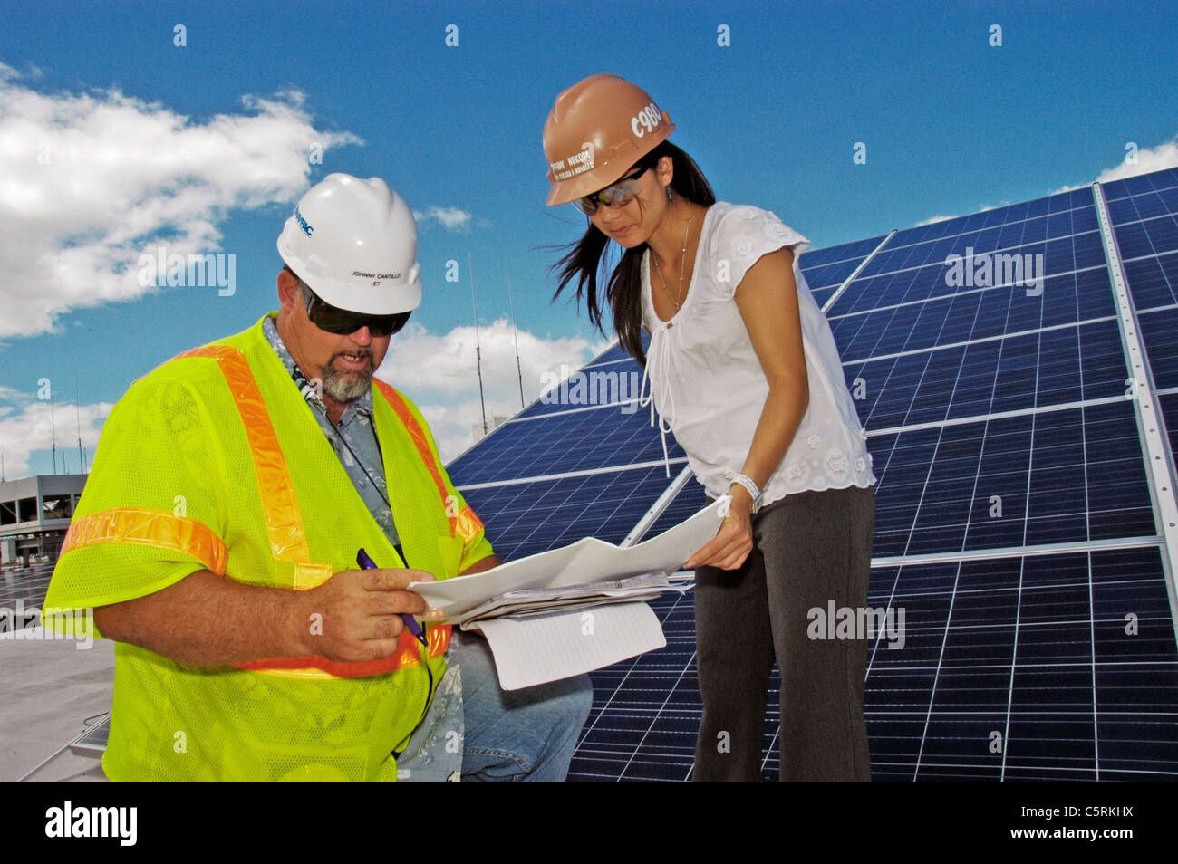 reviewing installation plans for a 20,000-square-foot rooftop photovoltaic system Stock Photo