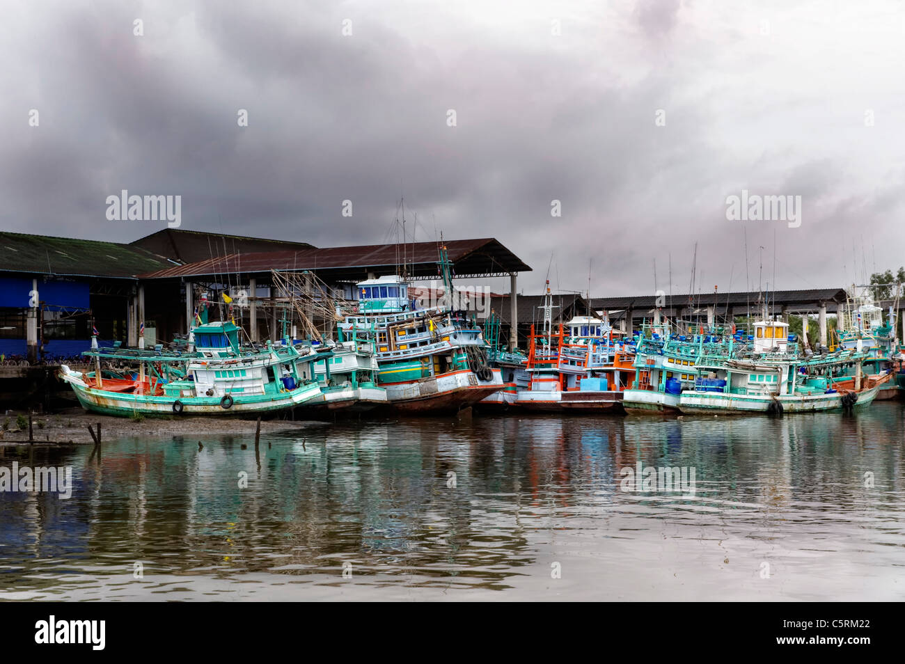 fishing boats at low tide in the harbor channel Thailand Stock Photo