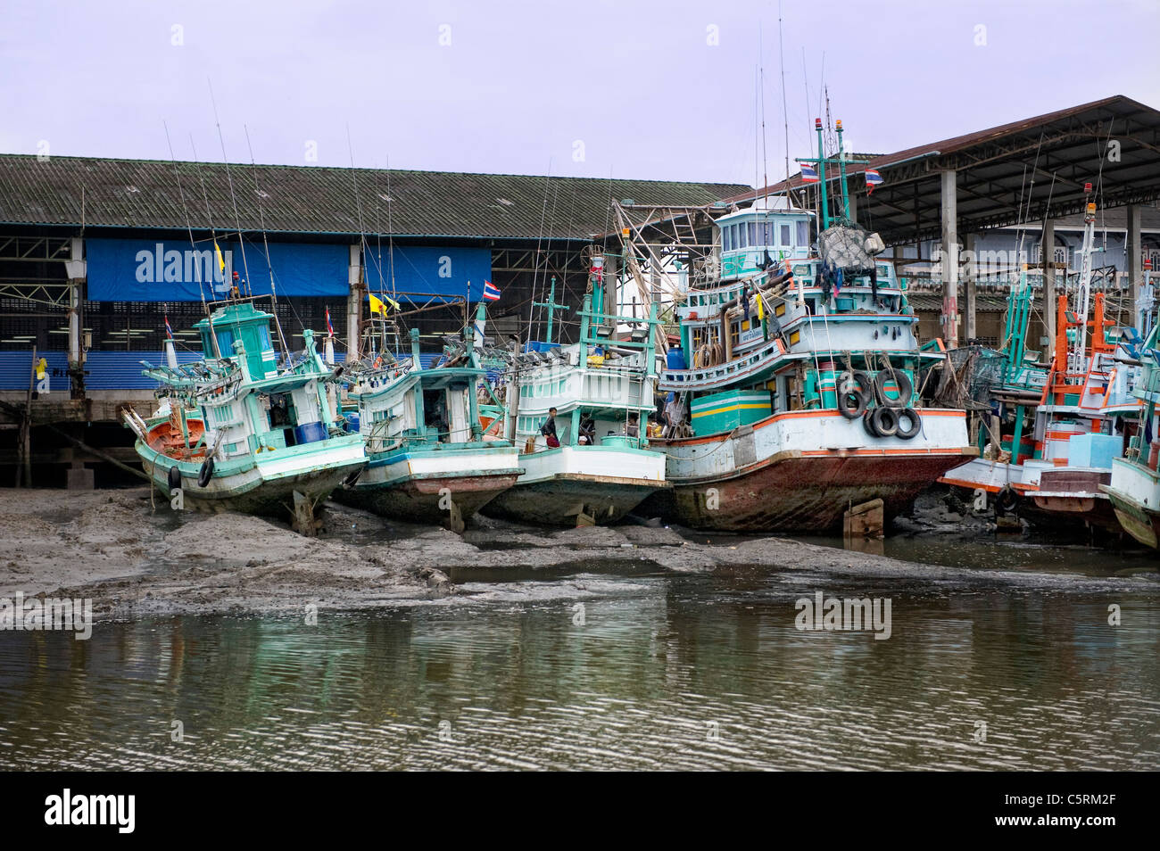 fishing boats beached during low tide Stock Photo