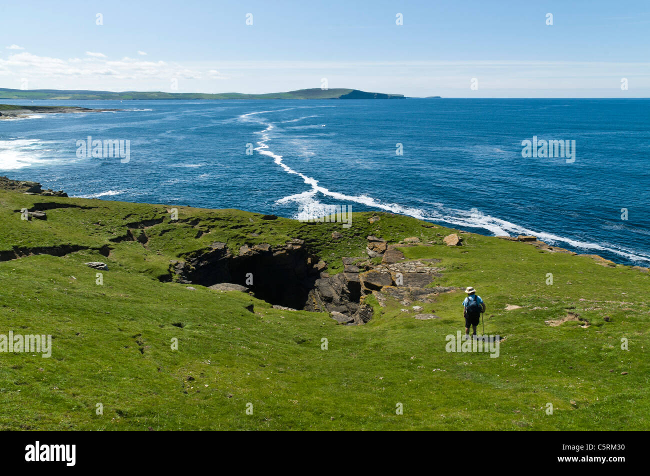 dh Scottish coast Geo hiker ROUSAY ISLAND ORKNEY ISLES Rousay tourist look at seacliff scotland people coastal erosion sea Stock Photo