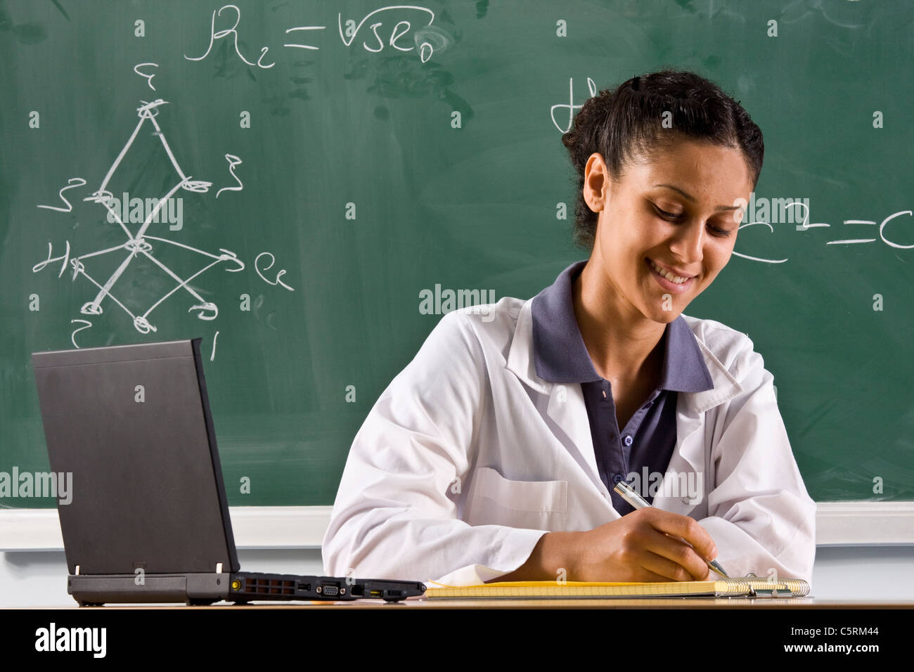 adult teacher is standing near chalkboard Stock Photo