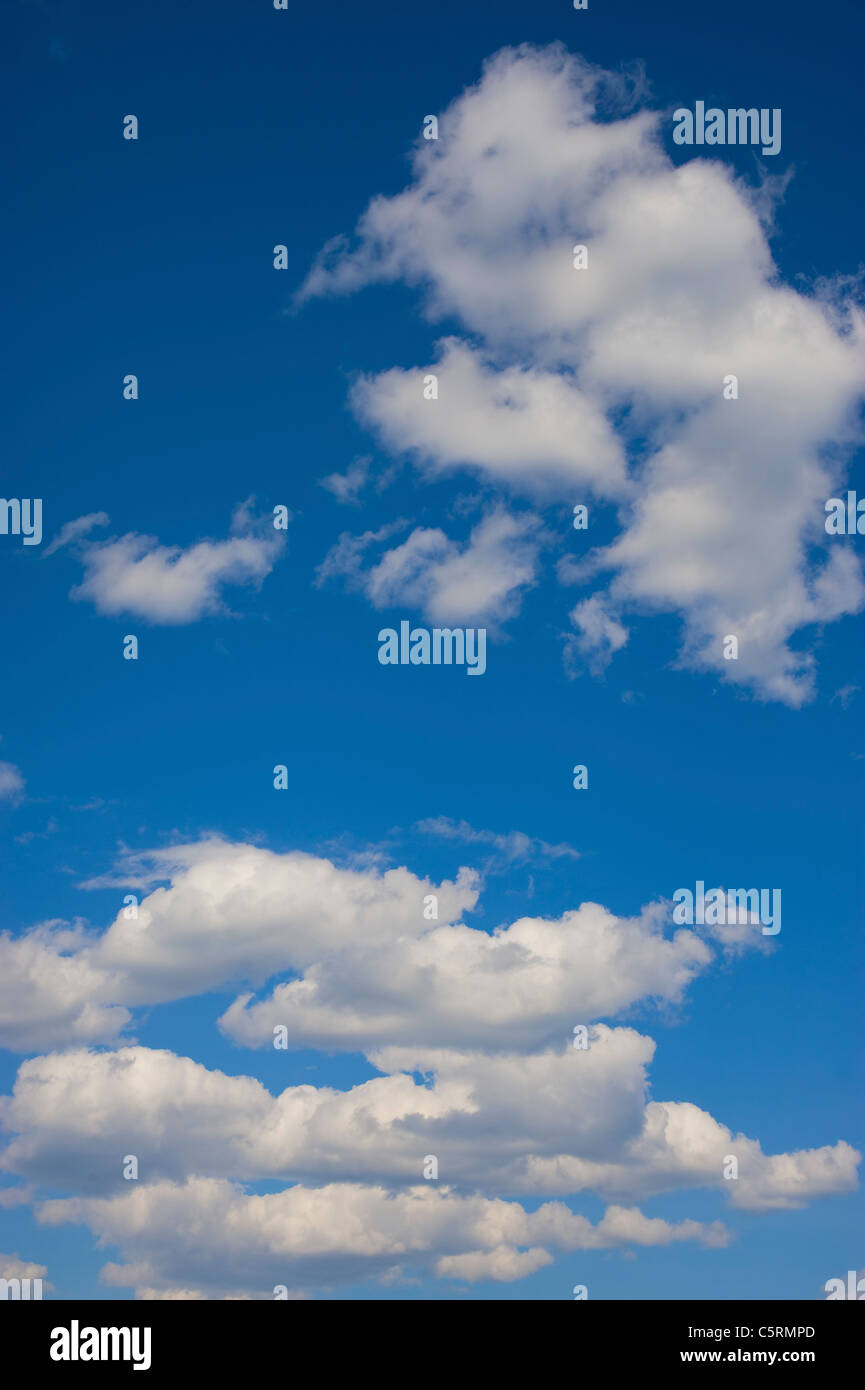 A bright blue sky with some puffy white clouds Stock Photo
