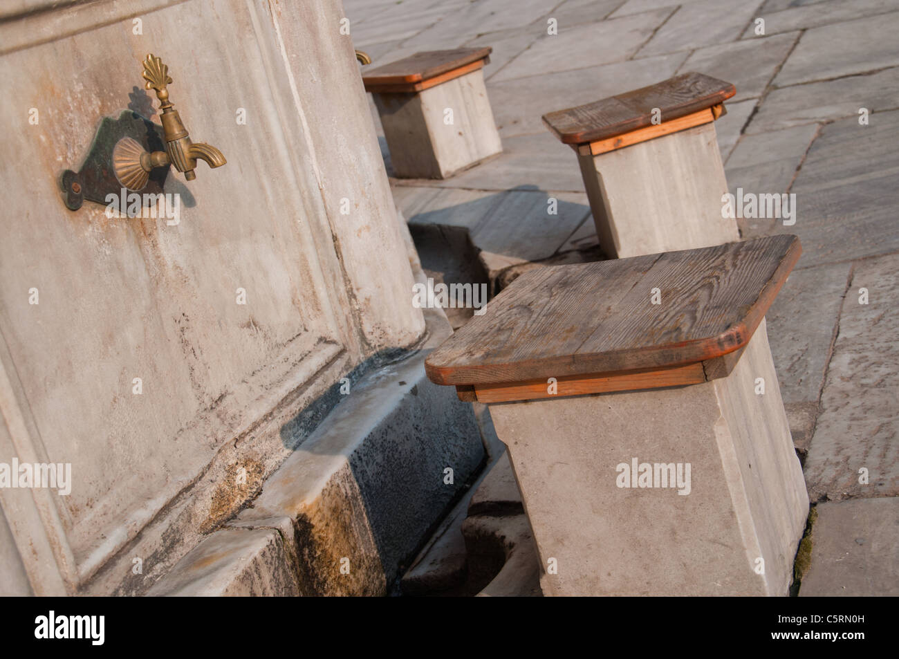 Tap and stool for washing feet before prayer, Istanbul, Turkey Stock Photo