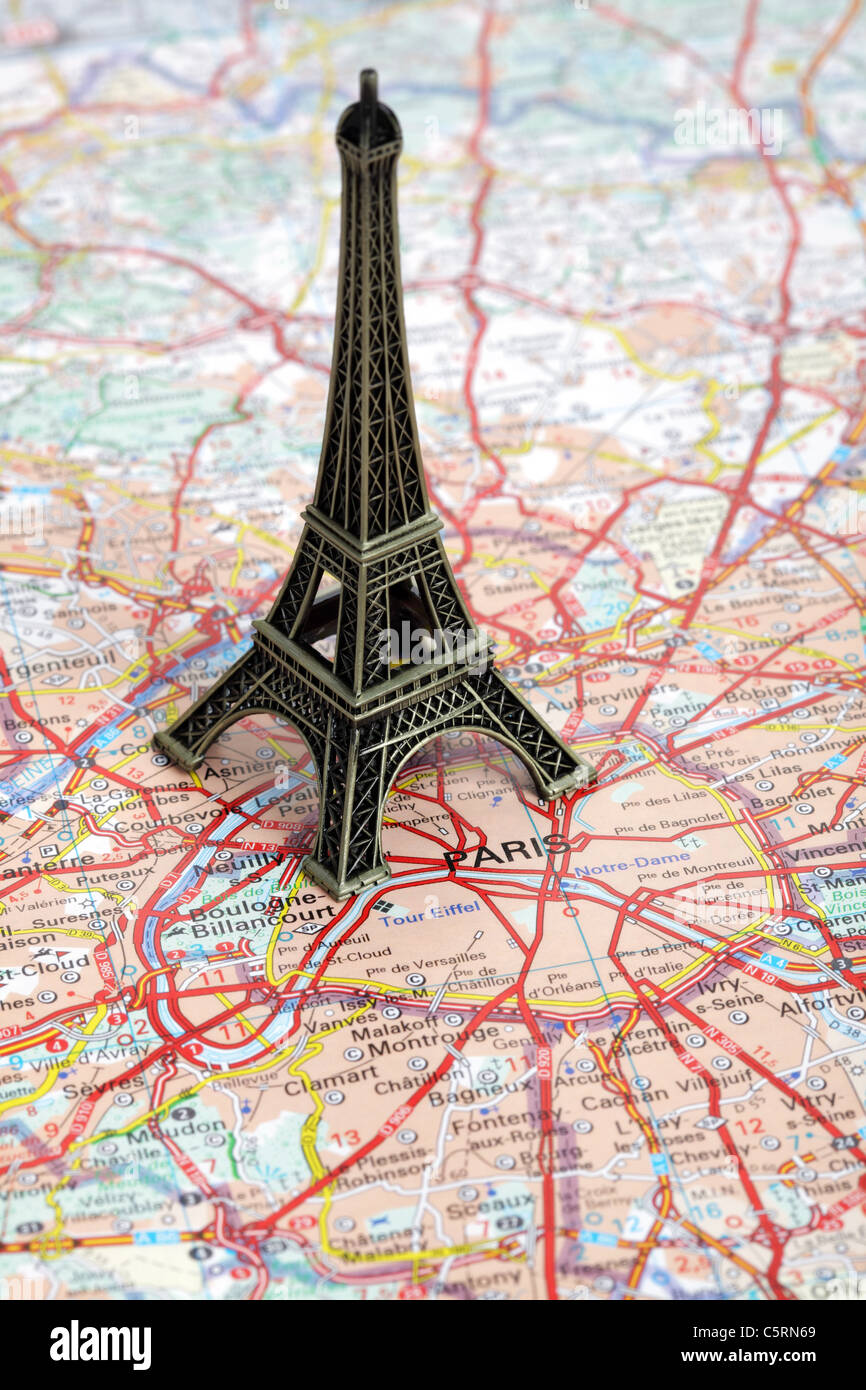 Statue of Eiffel Tower on map of Paris Stock Photo