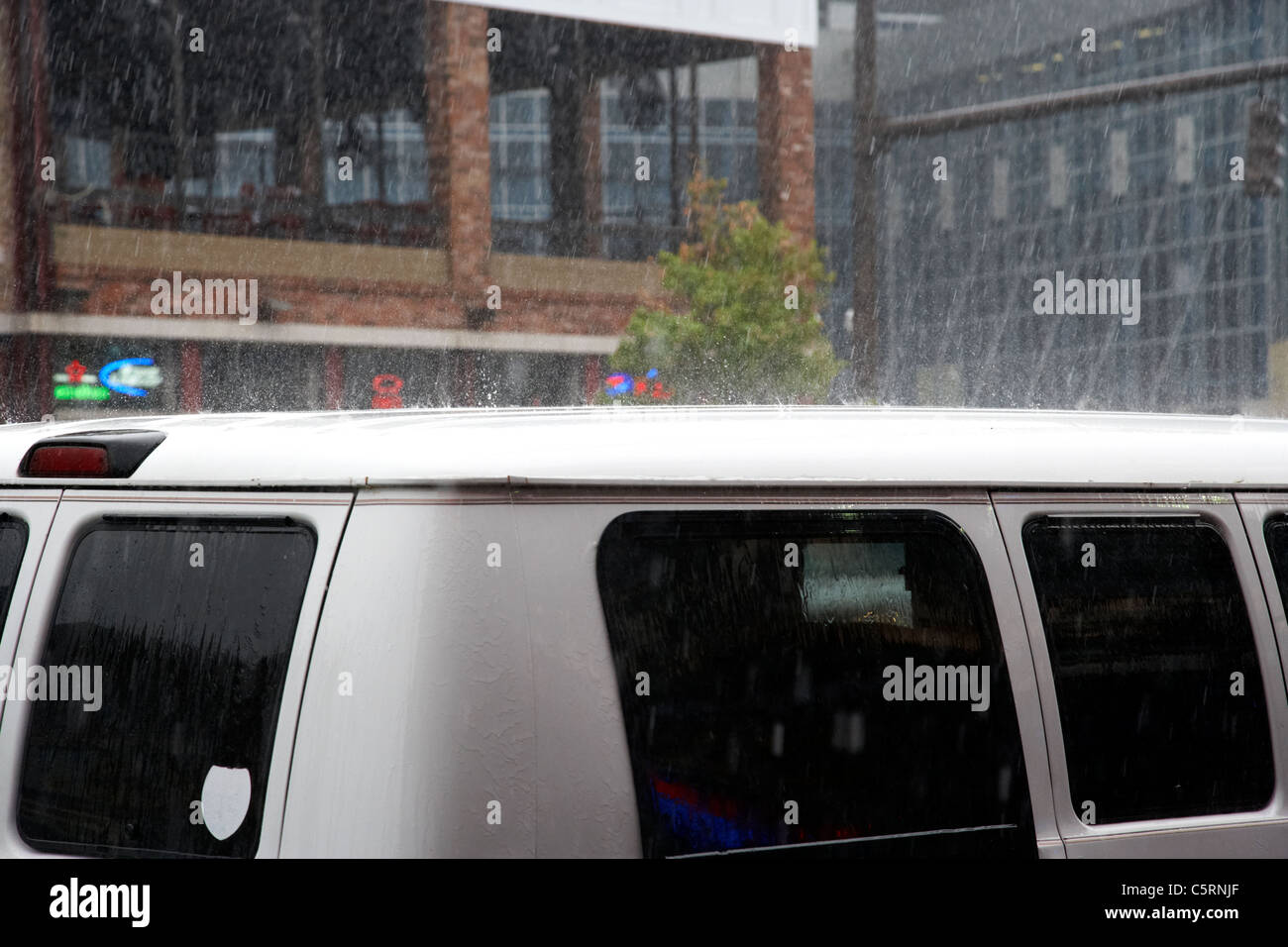 heavy rain bouncing off minivan roof in downtown broadway Nashville Tennessee USA Stock Photo
