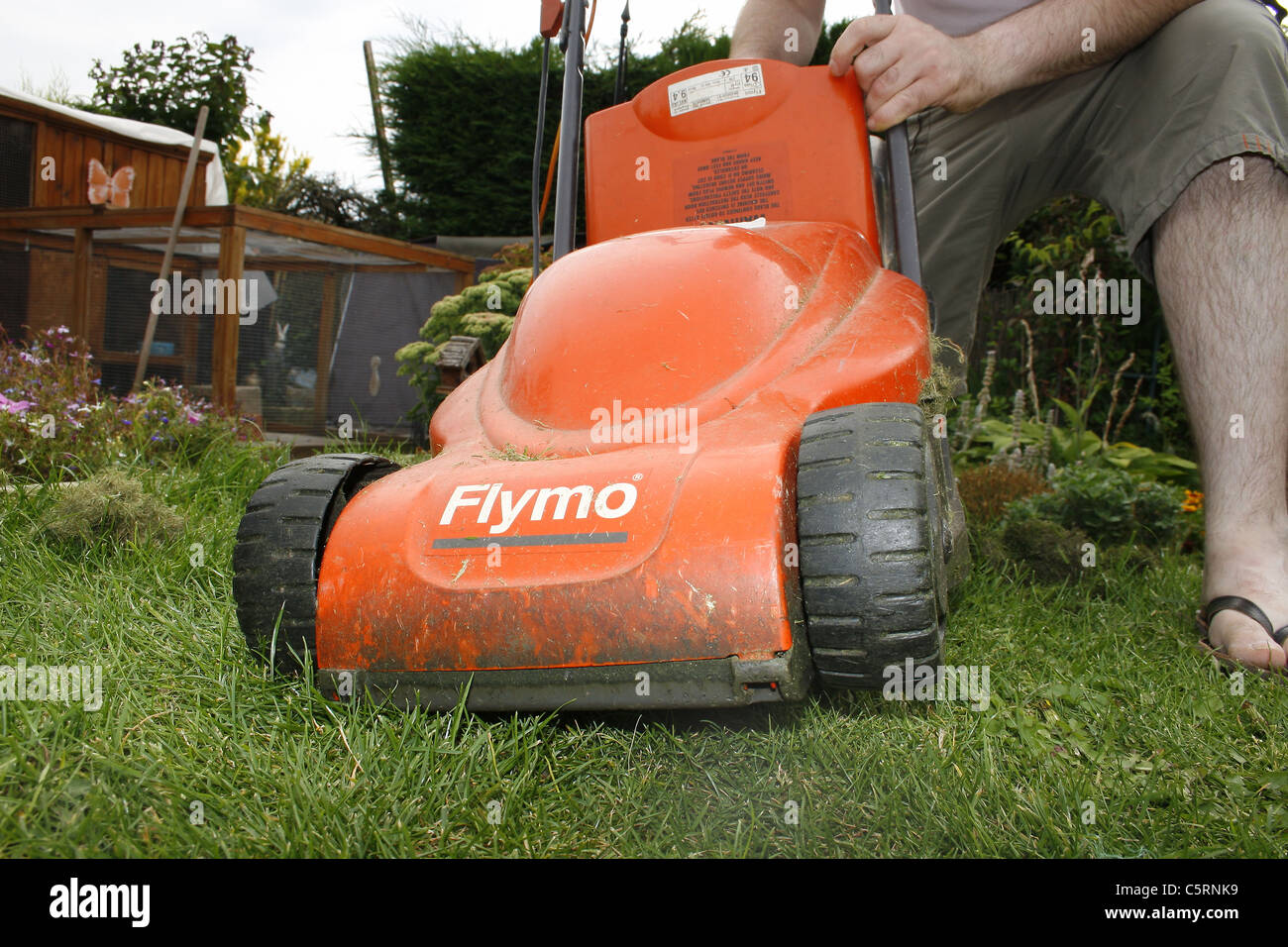man about to mow lawn with flymo Stock Photo