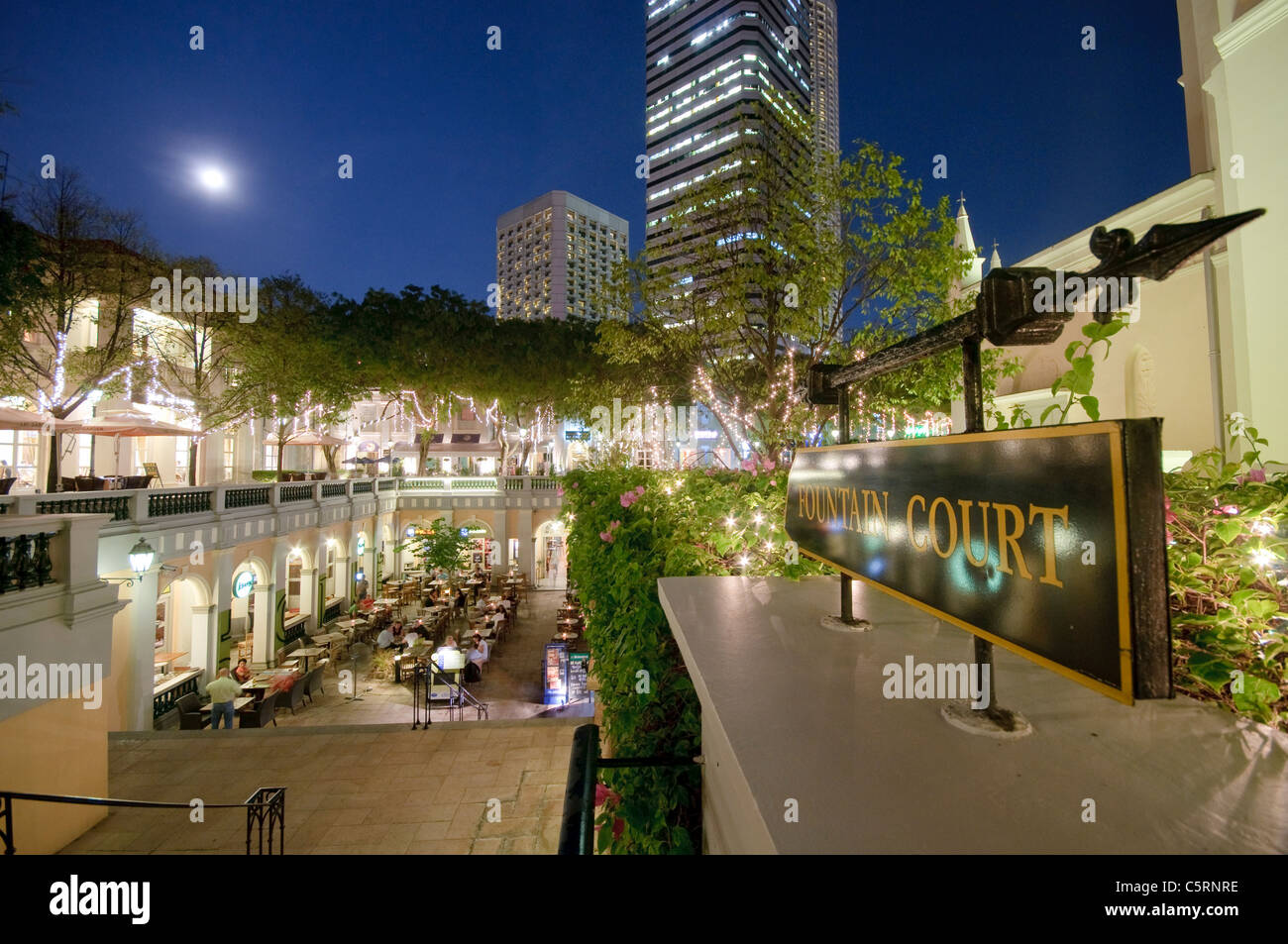 Restaurants and bars at Fountain Court at night, office building at