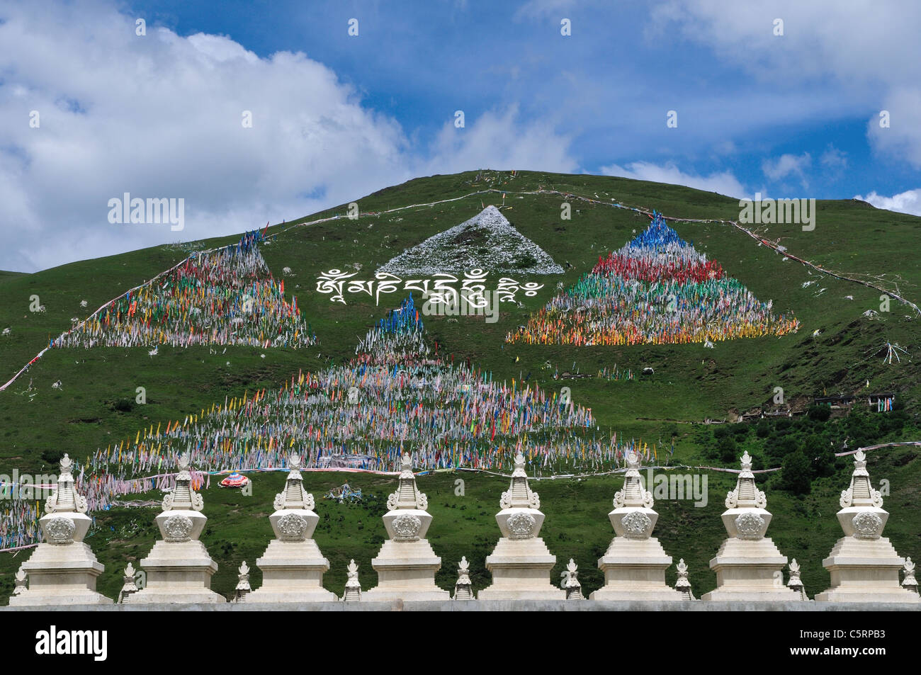 Tibetan prayer flags cover side of a hill. Tagong, Sichuan, China. Stock Photo