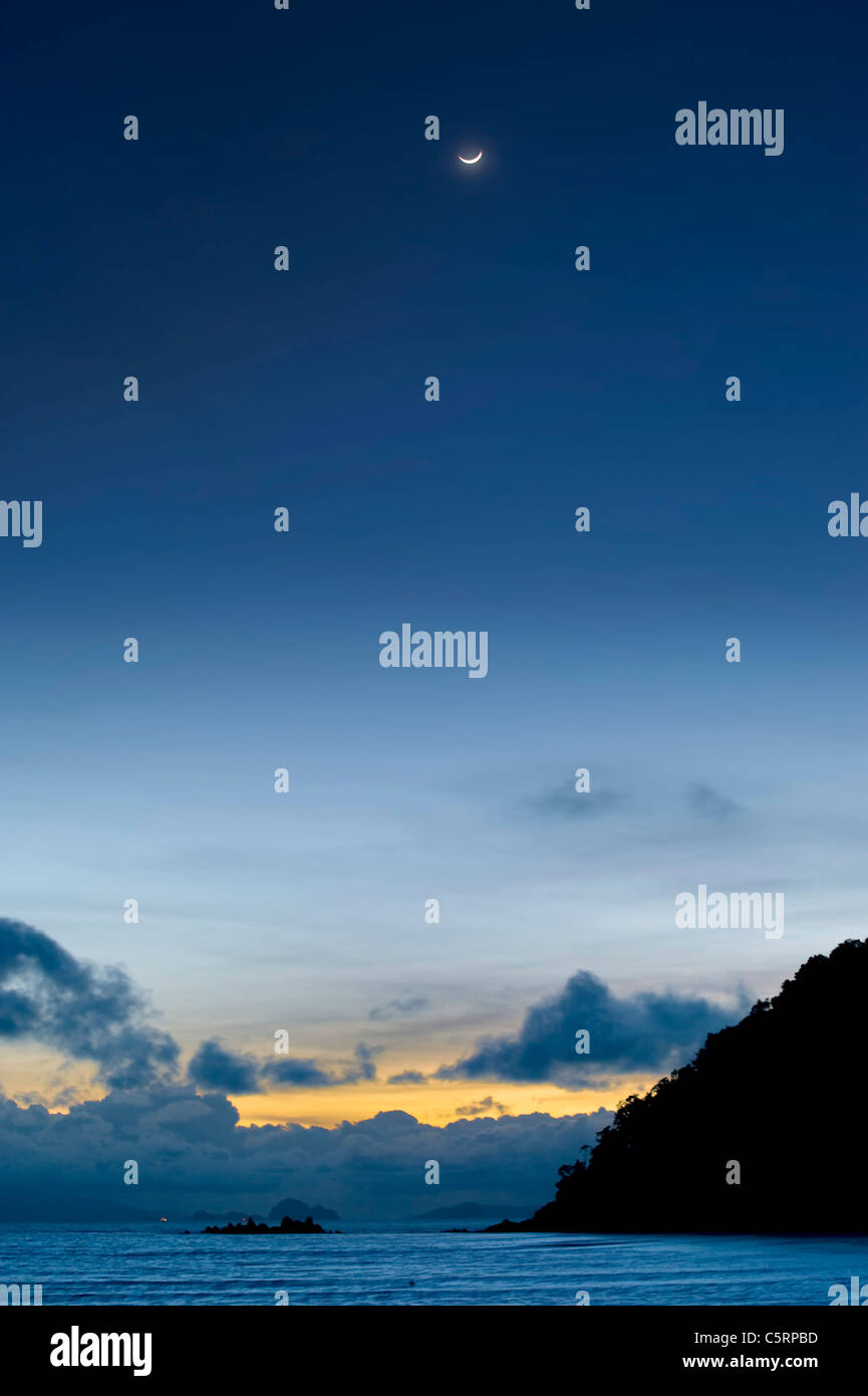 moon rise and sunset  combined from an island in Thailand Stock Photo