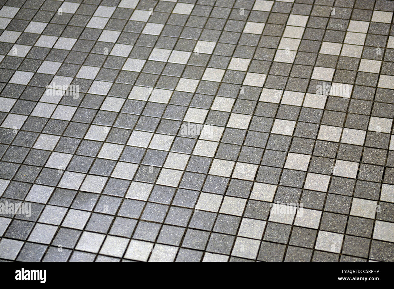 A view of a gray and white tile floor that can be used as a background or a texture. Stock Photo