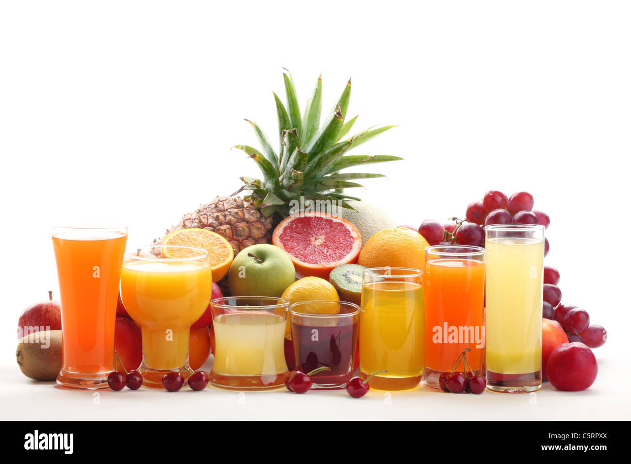 Glasses of fruit juice with fruits on white background. Stock Photo