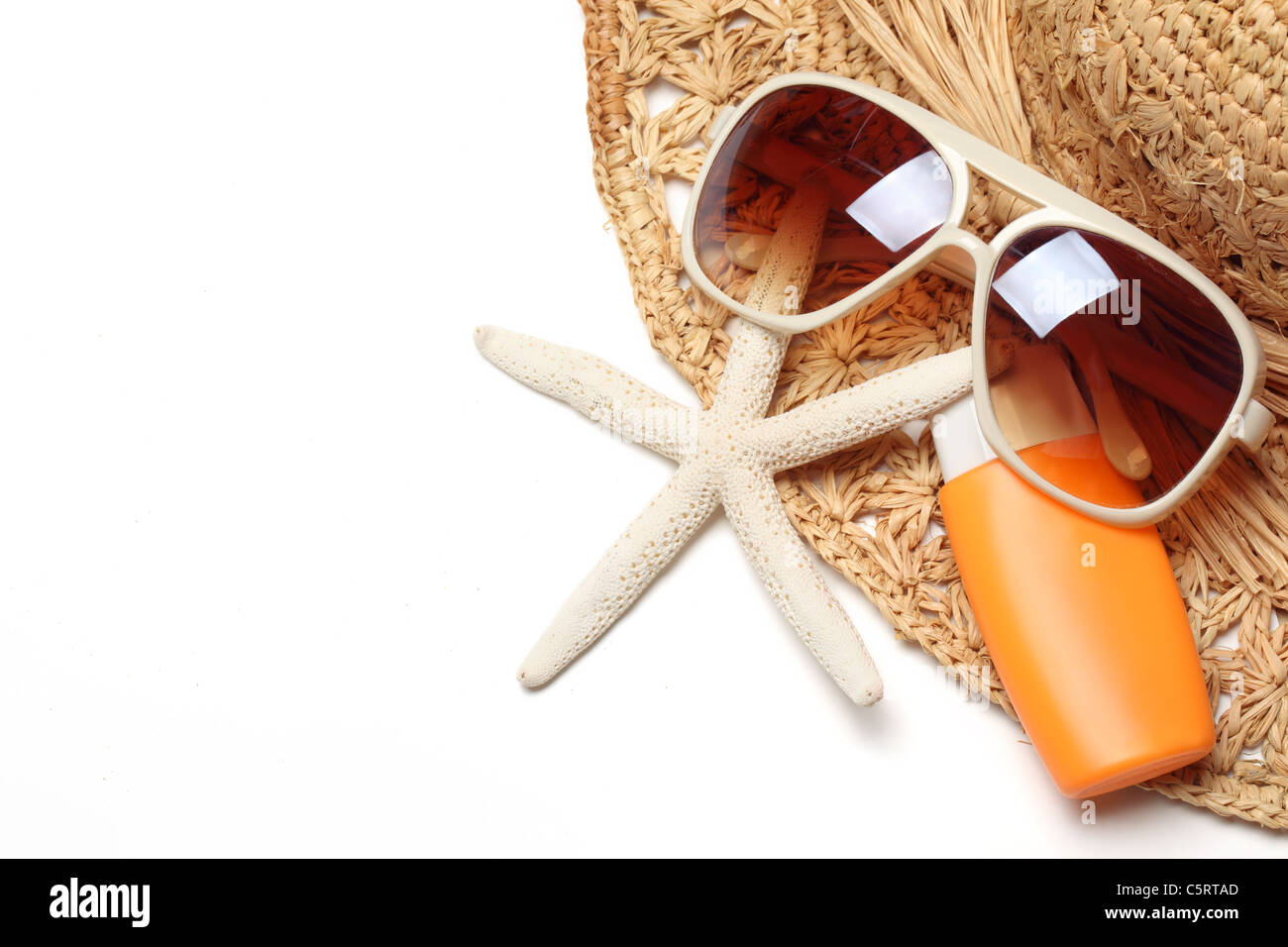 Sunglasses,sunblock and straw hat isolated on white background Stock Photo  - Alamy